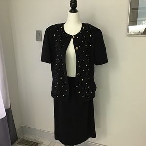 Two piece black top and skirt with gold studs and buttons